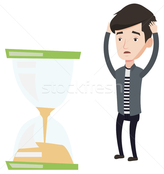 Desperate businessman looking at hourglass. Stock photo © RAStudio