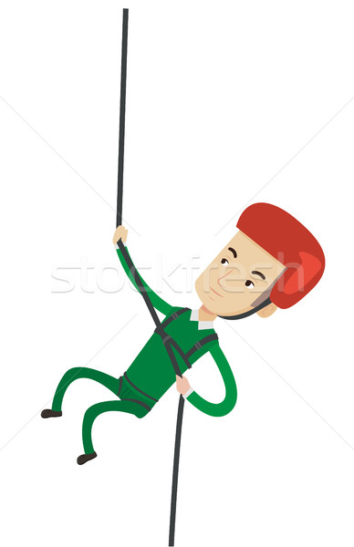 Man climbing in mountains with rope. Stock photo © RAStudio