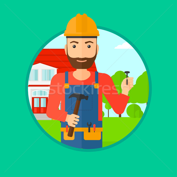 Cheerful builder with hammer. Stock photo © RAStudio