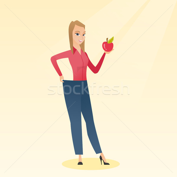Slim woman in pants showing results of her diet. Stock photo © RAStudio