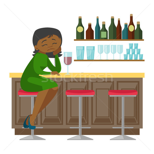 Sad african-american woman drinking wine in a bar. Stock photo © RAStudio
