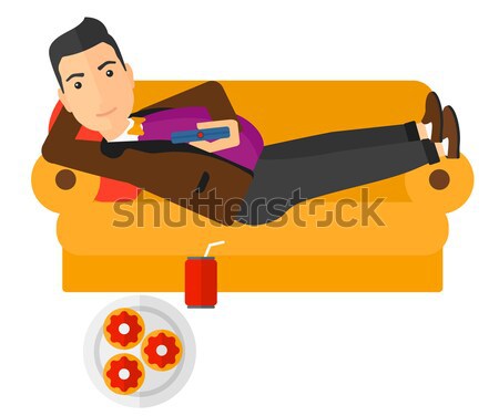 Woman lying on sofa with junk food. Stock photo © RAStudio