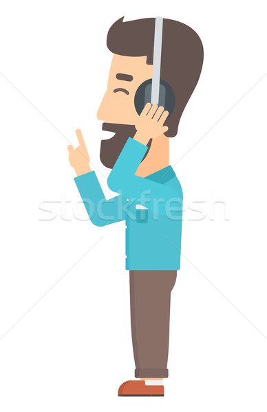 Hombre escuchar música auriculares barba Foto stock © RAStudio
