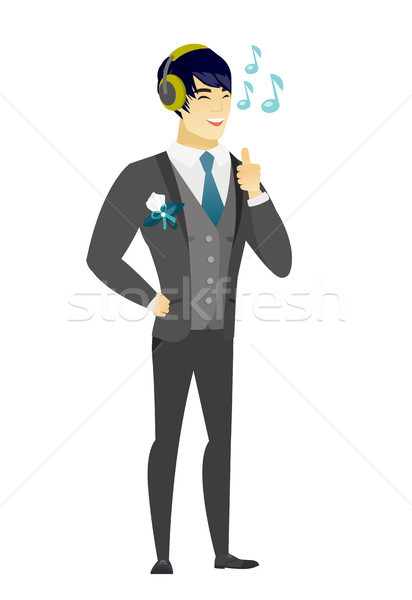 Groom listening to music in headphones. Stock photo © RAStudio