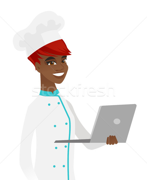 Young african-american chef using a laptop. Stock photo © RAStudio