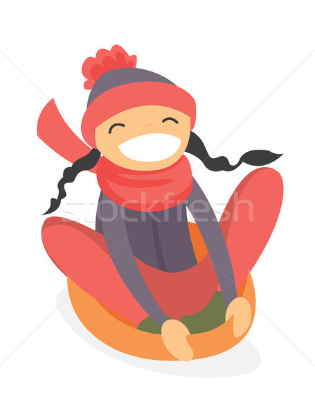 Caucasian girl sledding down on snow rubber tube. Stock photo © RAStudio