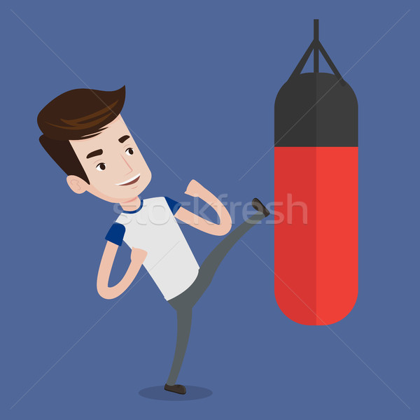 Man exercising with punching bag. Stock photo © RAStudio