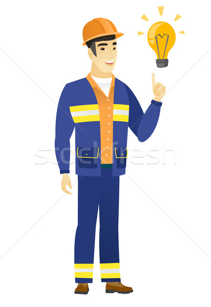 Builder pointing at bright idea light bulb. Stock photo © RAStudio