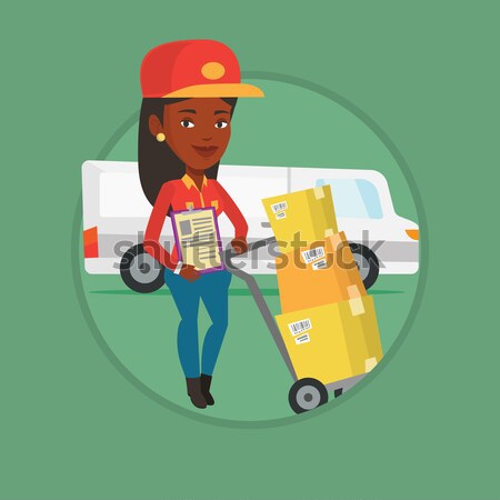 Delivery courier with cardboard boxes on troley. Stock photo © RAStudio