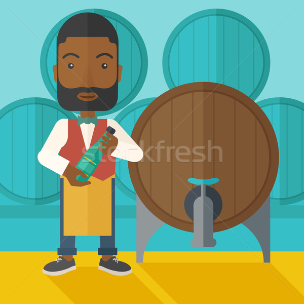 African Wine maker inspecting wine from barrel. Stock photo © RAStudio