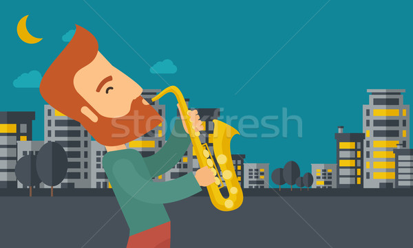 Saxophonist playing in the streets at night Stock photo © RAStudio