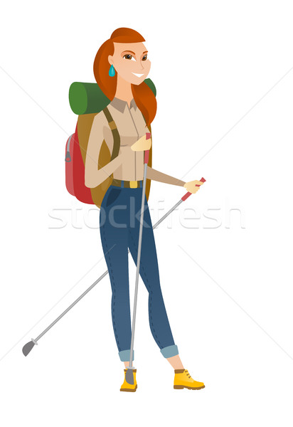 Caucasian woman hiker walking with trekking sticks Stock photo © RAStudio
