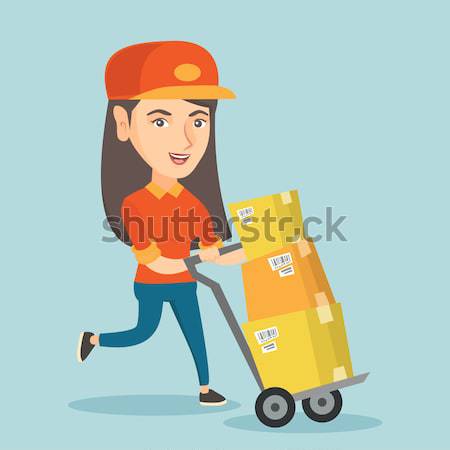 Stock photo: Woman-postman pushing the trolley with parcels.