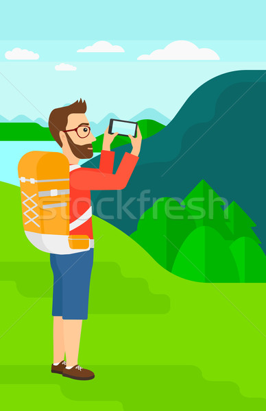 Backpacker taking photo. Stock photo © RAStudio