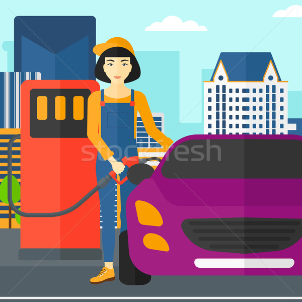 Stock photo: Woman filling up fuel into car.
