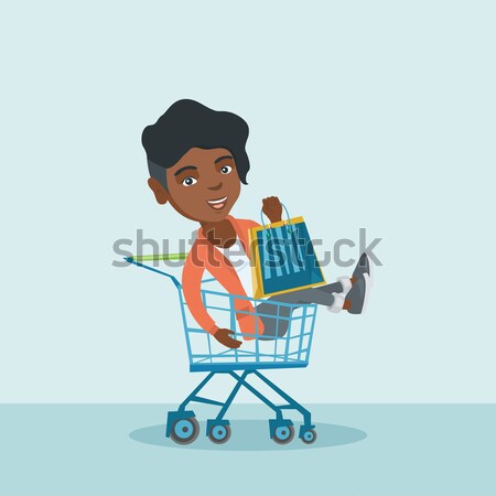 Happy woman riding by shopping trolley. Stock photo © RAStudio