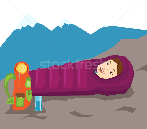 Woman resting in sleeping bag in the mountains. Stock photo © RAStudio