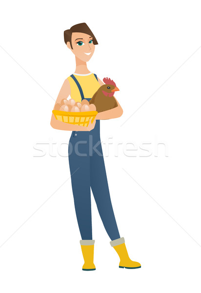 Farmer holding chicken and basket of eggs. Stock photo © RAStudio