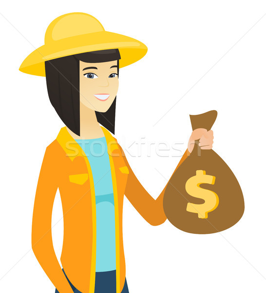 Young asian farmer holding a money bag. Stock photo © RAStudio