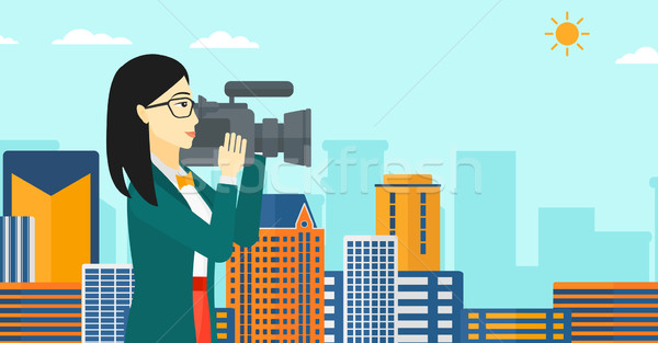 Stock photo: Camerawoman with video camera.