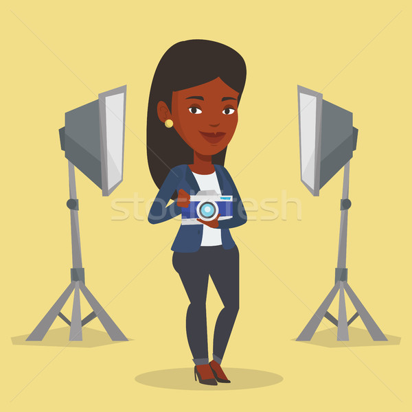 Stock photo: Photographer with camera in photo studio.