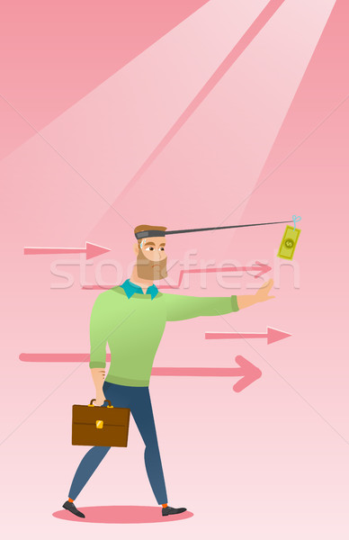 Businessman trying to catch money on fishing rod. Stock photo © RAStudio