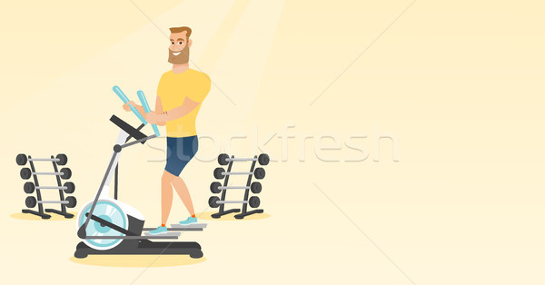 Man exercising on elliptical trainer. Stock photo © RAStudio
