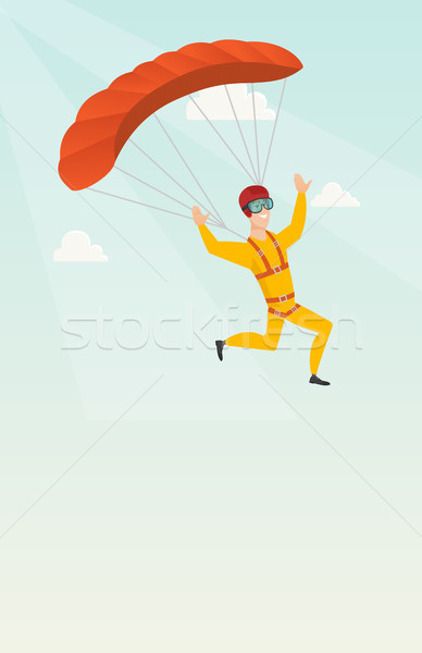 Young caucasian skydiver flying with a parachute. Stock photo © RAStudio