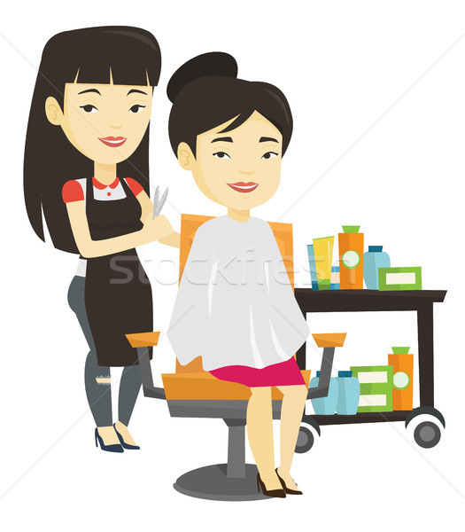 Stock photo: Hairdresser making haircut to young woman.