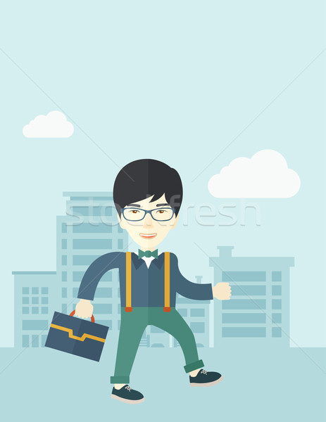 Young man walking through the city street with his briefcase. Stock photo © RAStudio