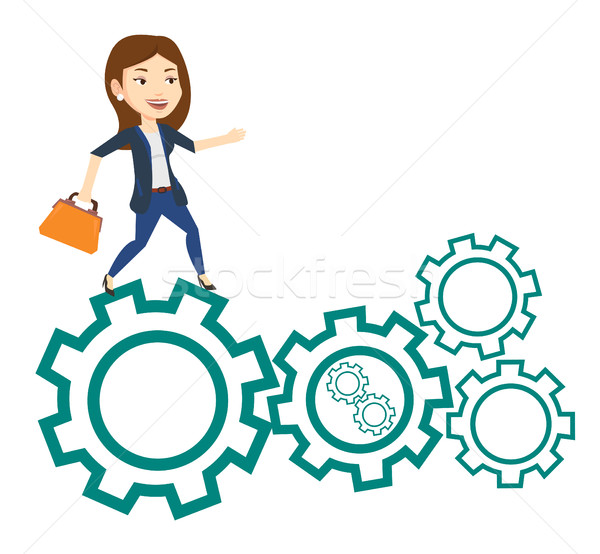 Business woman running on cogwheels. Stock photo © RAStudio