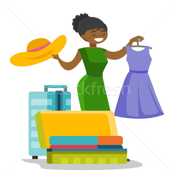 African-american woman packing clothes in suitcase Stock photo © RAStudio