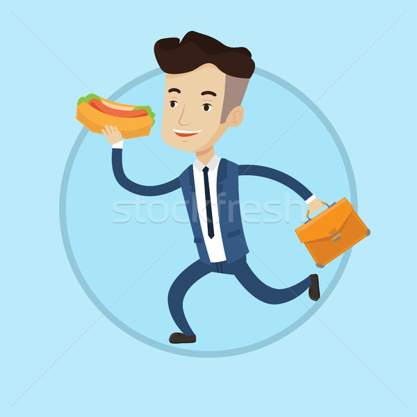 Businessman eating hot dog on the run. Stock photo © RAStudio