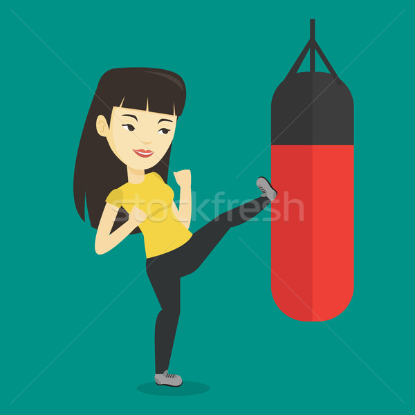 Woman exercising with punching bag. Stock photo © RAStudio