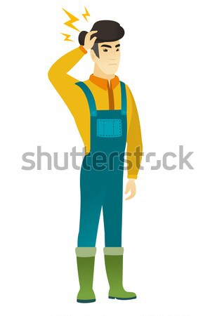 Disappointed asian farmer with thumb down. Stock photo © RAStudio