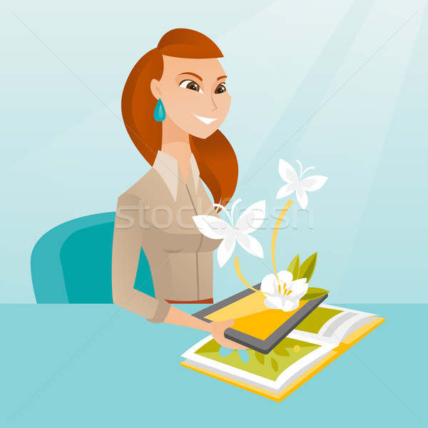 Young woman holding tablet computer above the book Stock photo © RAStudio