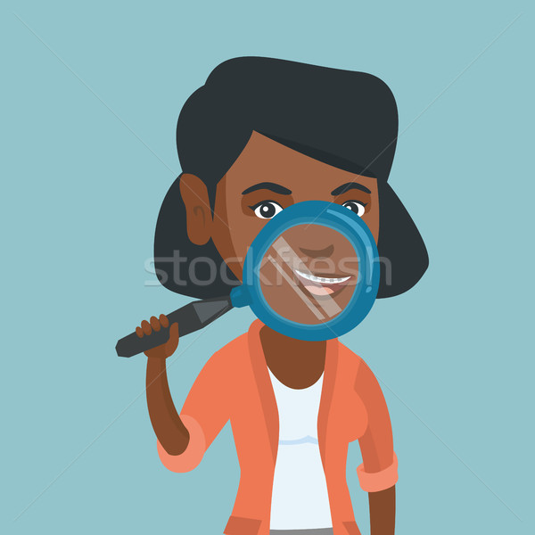 African woman examining her teeth with a magnifier Stock photo © RAStudio