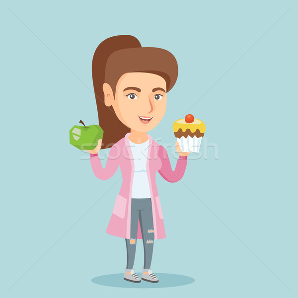 Caucasian woman choosing between apple and cupcake Stock photo © RAStudio