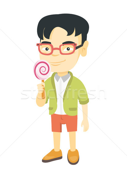 Little asian boy holding a lollipop candy. Stock photo © RAStudio