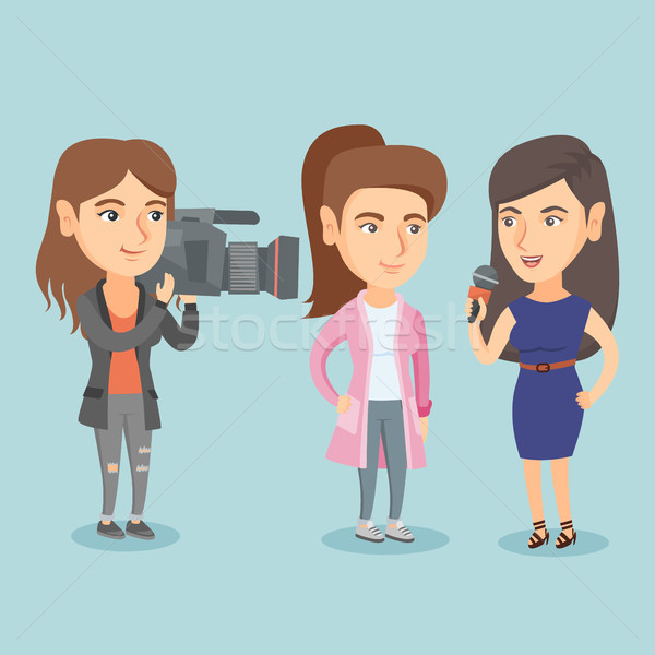 Reporter with a microphone interviews a woman. Stock photo © RAStudio