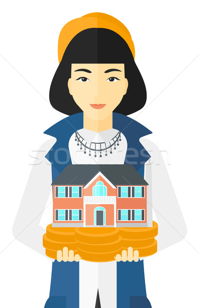 Woman holding house model. Stock photo © RAStudio