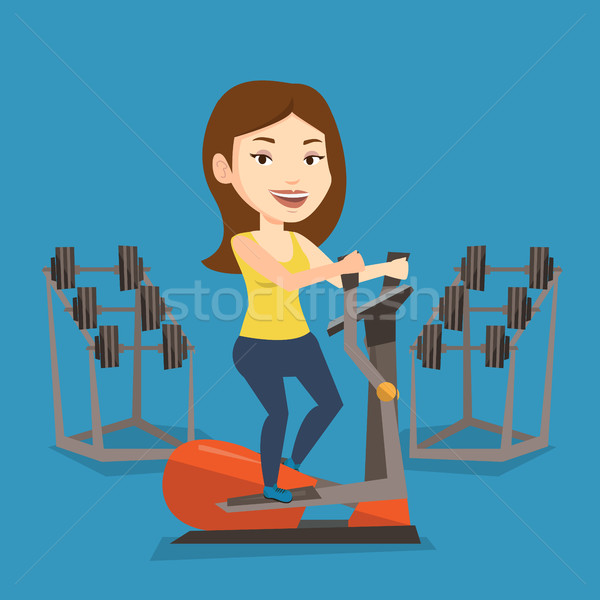 Woman exercising on elliptical trainer. Stock photo © RAStudio