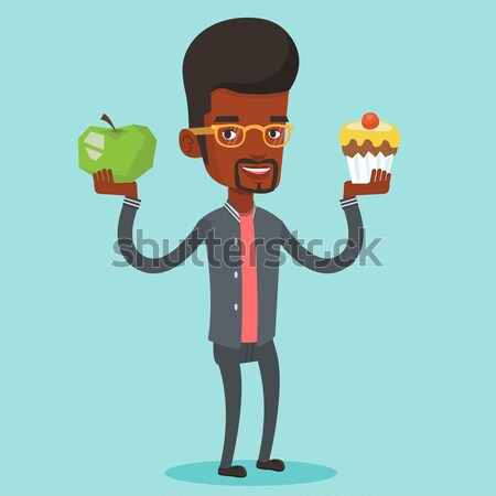Woman choosing between apple and cupcake. Stock photo © RAStudio