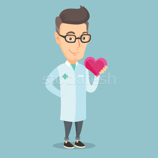 Doctor cardiologist holding heart. Stock photo © RAStudio