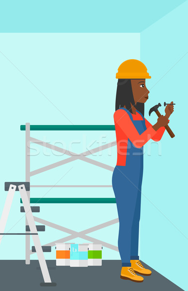 Constructor hammering nail. Stock photo © RAStudio