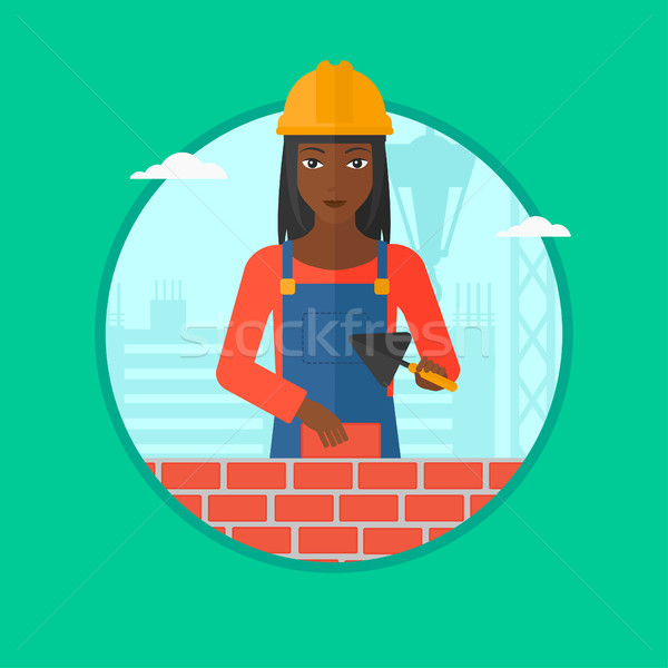 Bricklayer with spatula and brick. Stock photo © RAStudio