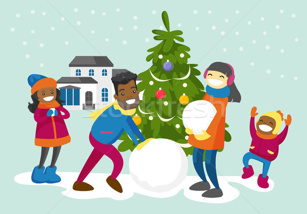 Multiracial family making a snowman in the yard. Stock photo © RAStudio