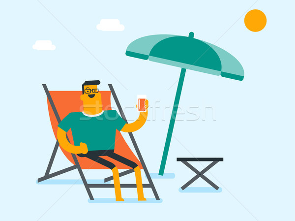 Young caucasian man relaxing on the beach chair. Stock photo © RAStudio