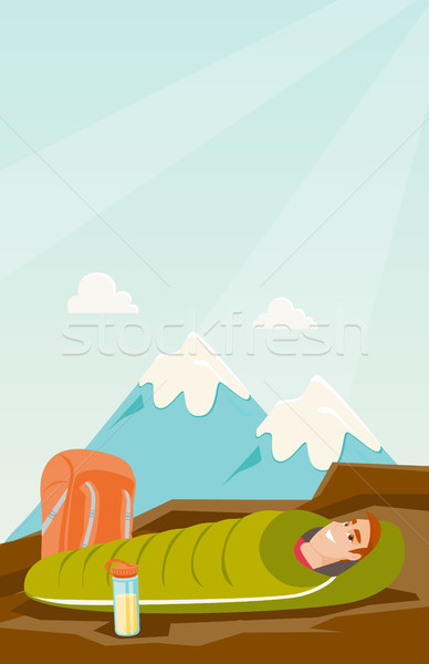 Man sleeping in a sleeping bag in the mountains. Stock photo © RAStudio