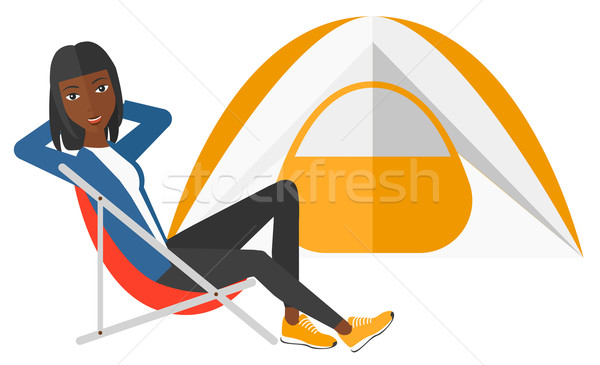 Woman sitting in folding chair. Stock photo © RAStudio
